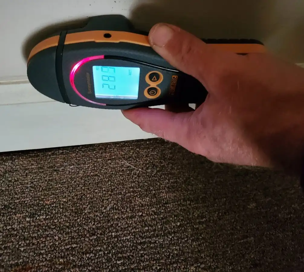 Moisture detection at baseboard during Storm Damage Restoration in Buxton